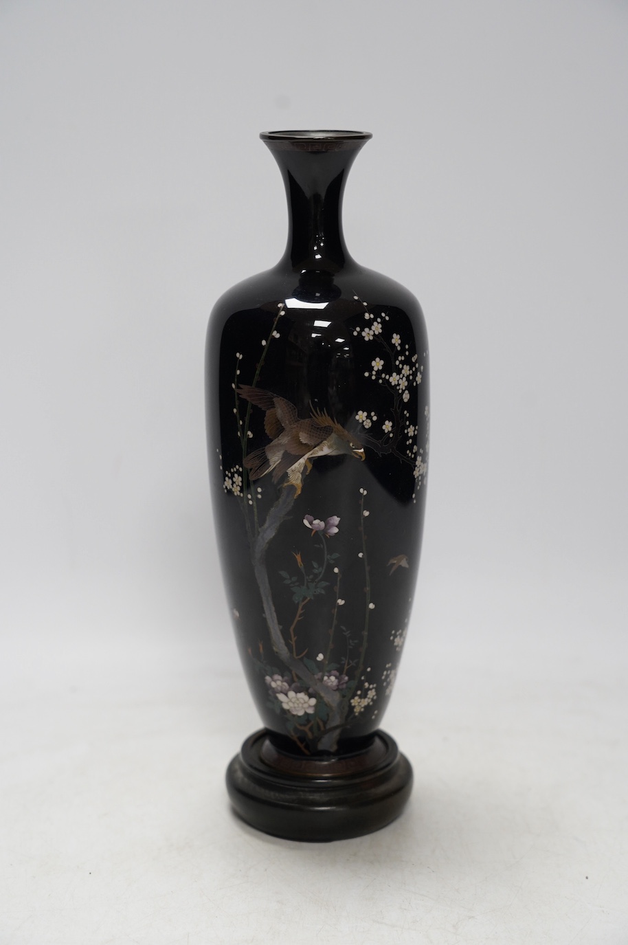 A Japanese cloisonné enamel ‘eagle’ vase, signed to base, on hardwood stand, 27cm total height. Condition - slight damage